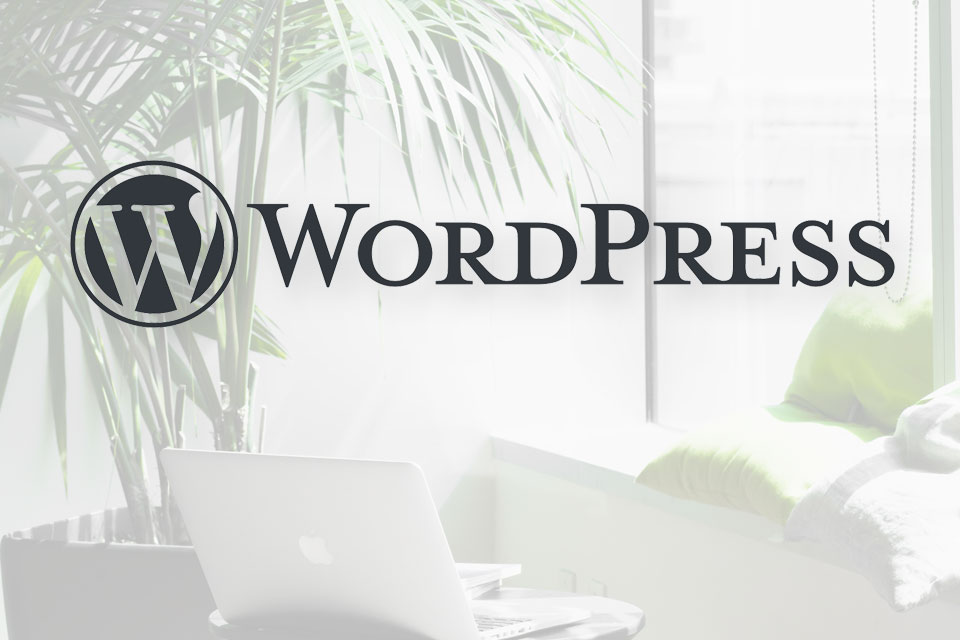 WordPress logo with laptop, window, potted plant, and pillows in the background